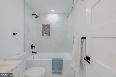 a bathroom with a toilet a sink and a bathtub