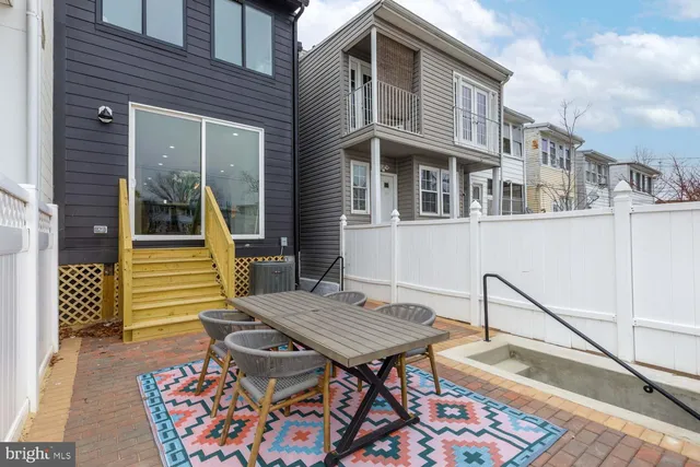 a view of a house with a wooden deck