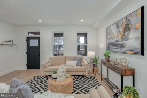 a bedroom with furniture and wooden floor