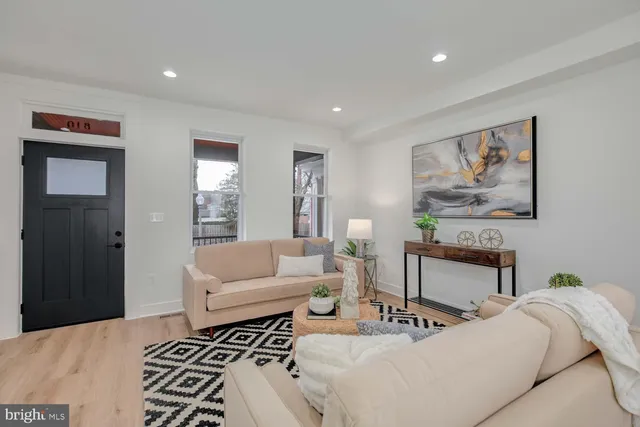 a living room with furniture and a painting on the wall