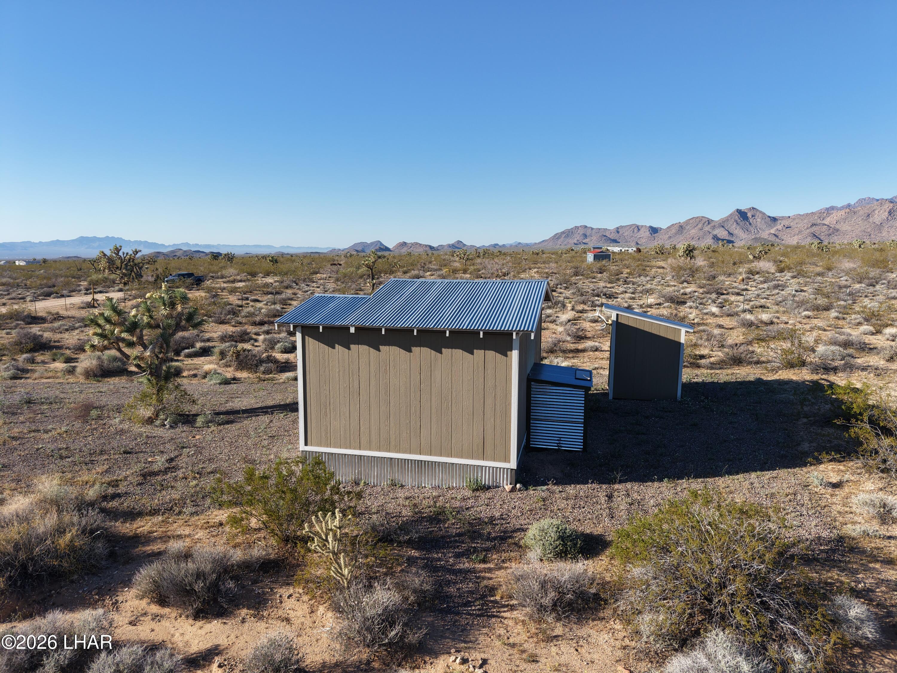 122 South Carrow Road Yucca, AZ 86438 - Photo 13 of 47 a view of a house with a yard