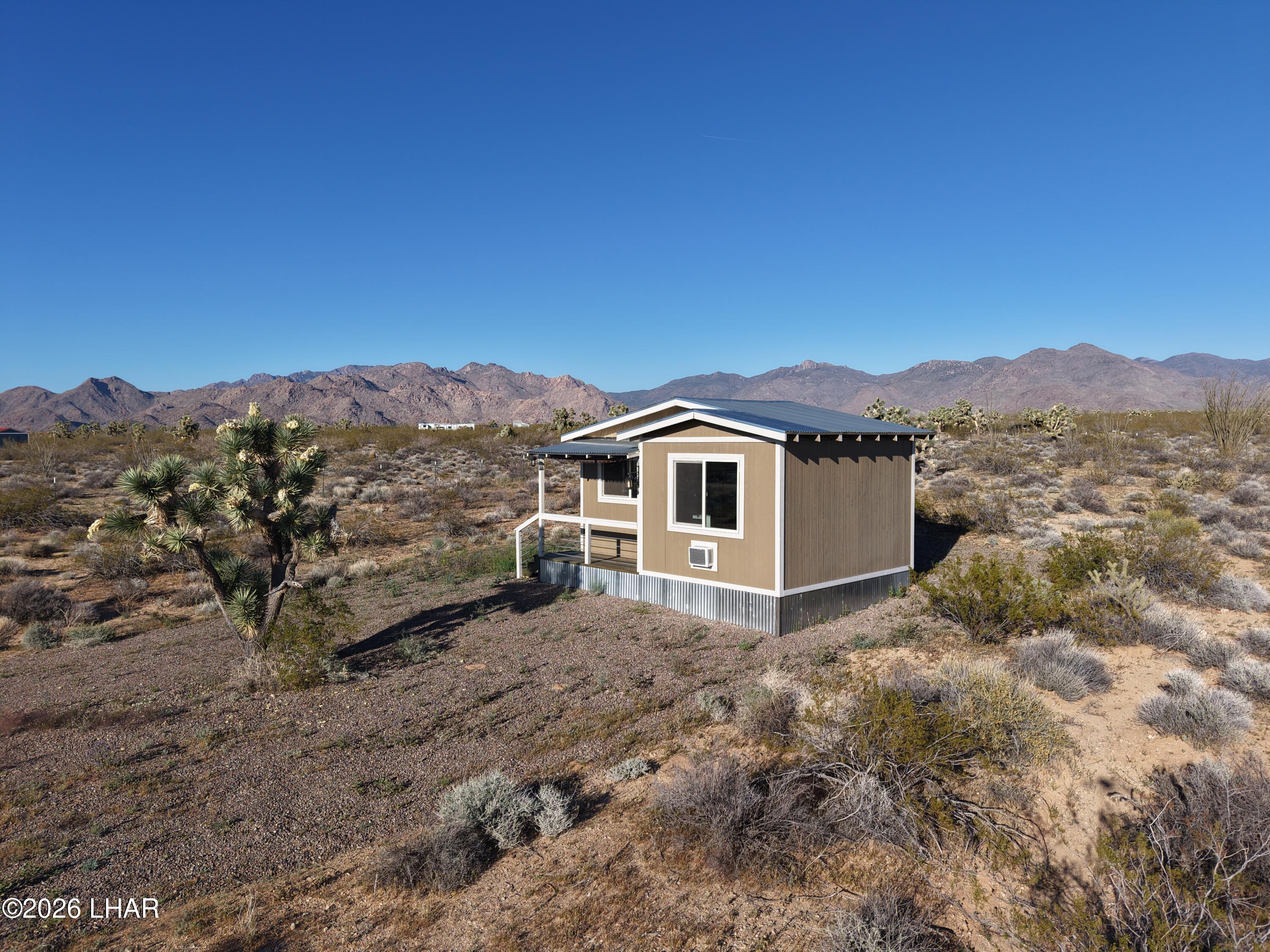 122 South Carrow Road Yucca, AZ 86438 - Photo 14 of 47 a view of a house with a yard