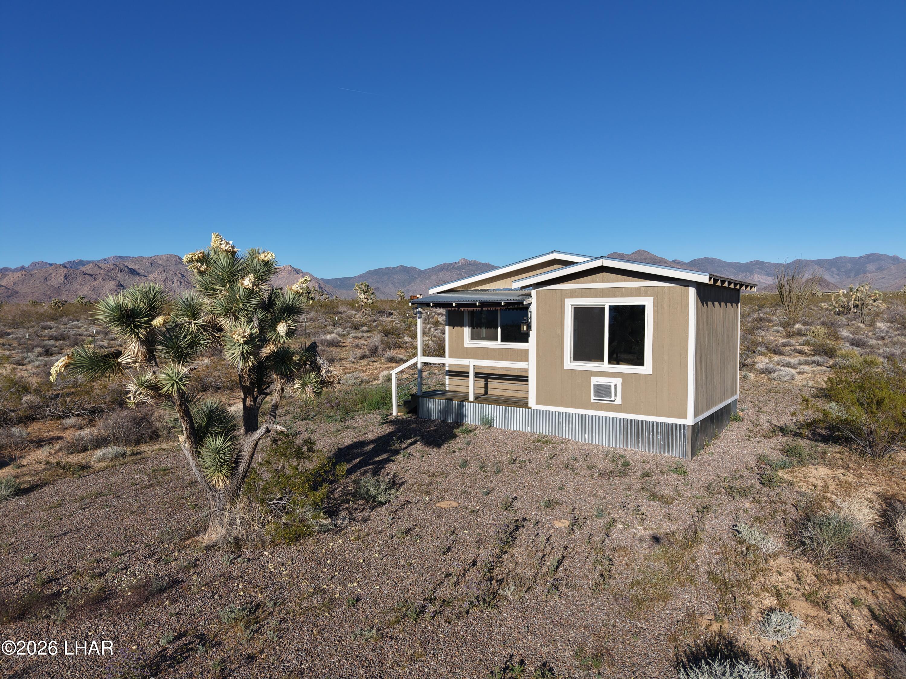 122 South Carrow Road Yucca, AZ 86438 - Photo 15 of 47 a view of a house with a yard