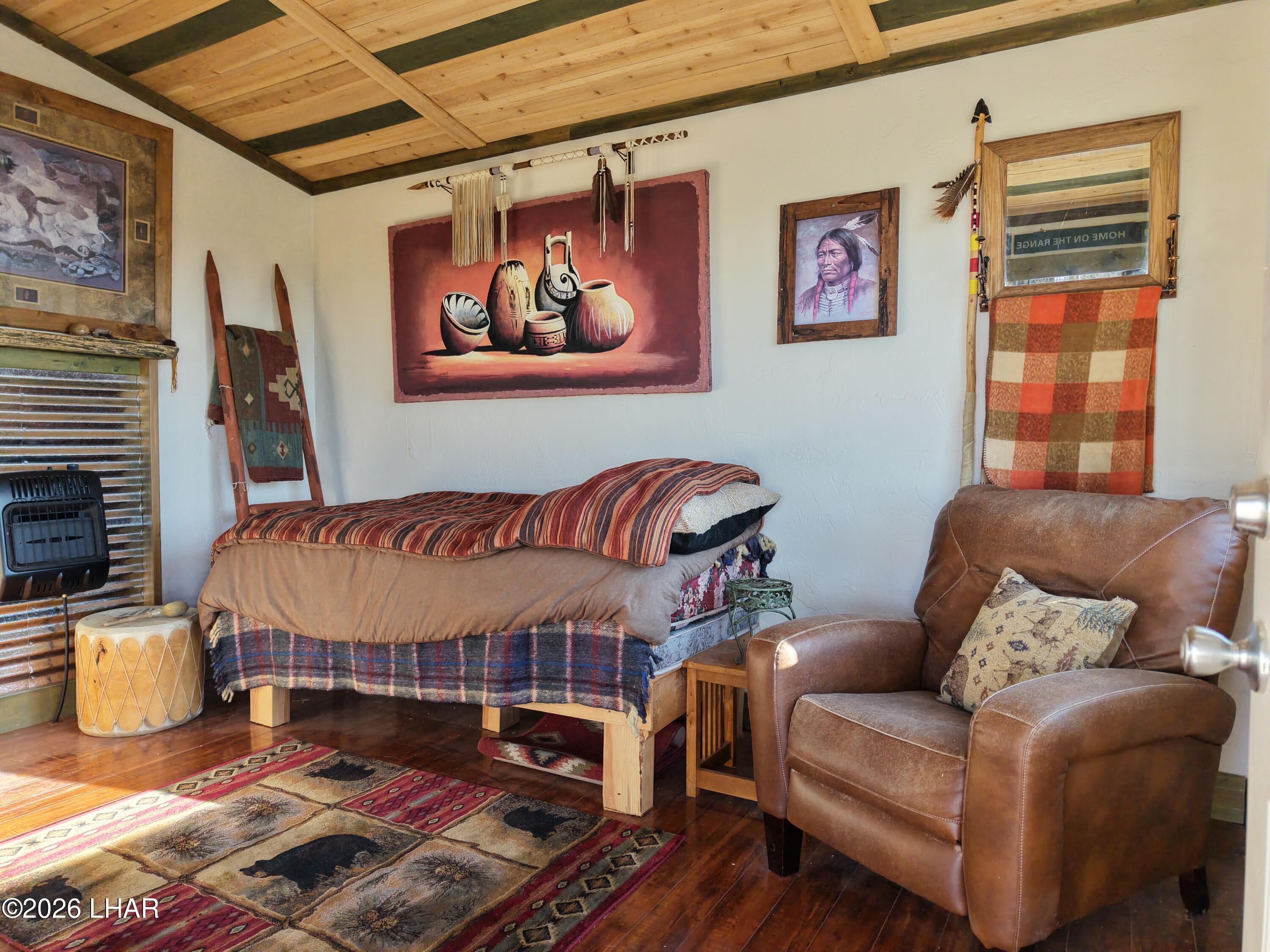 122 South Carrow Road Yucca, AZ 86438 - Photo 2 of 47 a living room with furniture a rug and a fireplace