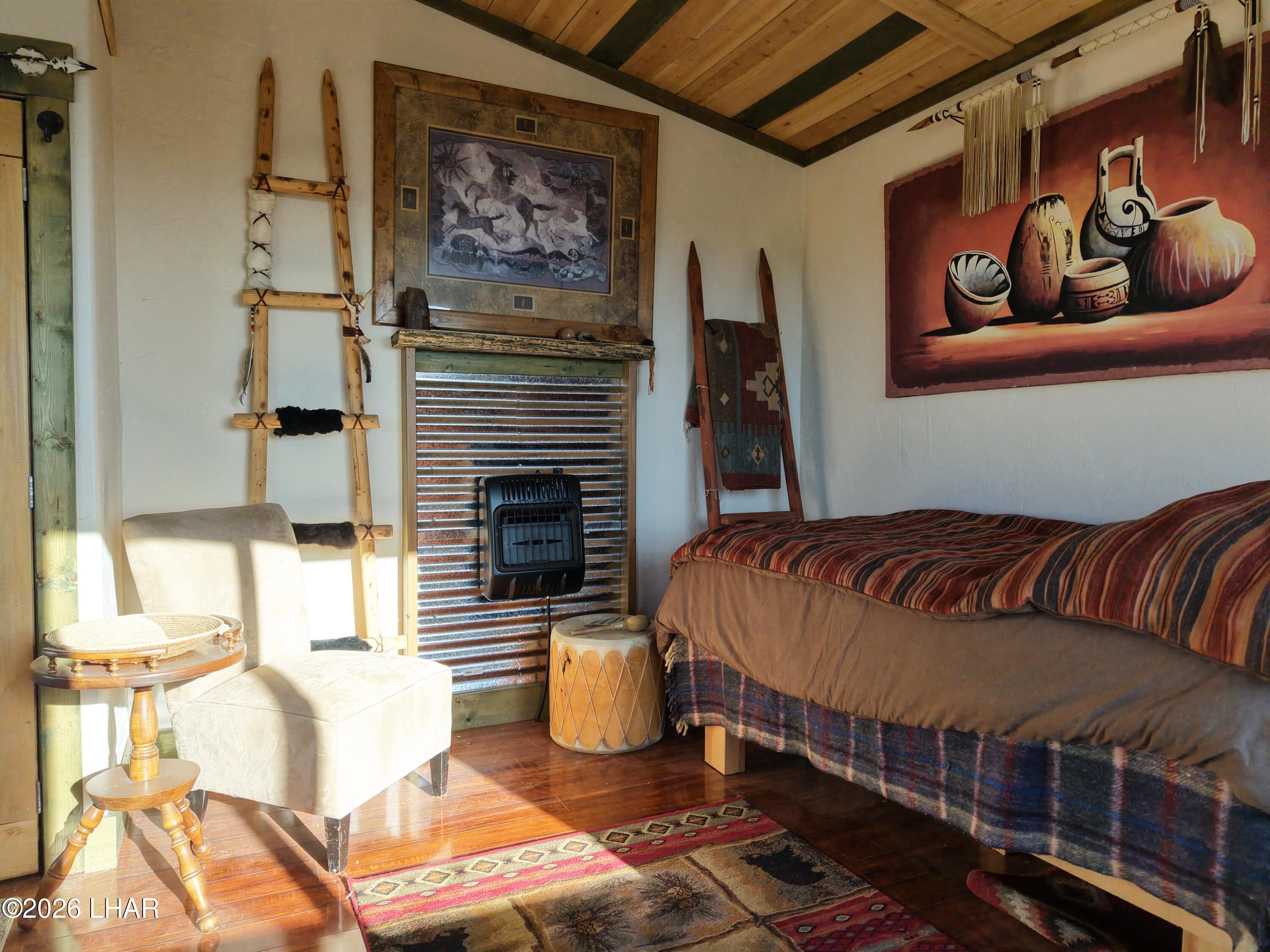 122 South Carrow Road Yucca, AZ 86438 - Photo 23 of 47 a bedroom with a bed and balcony
