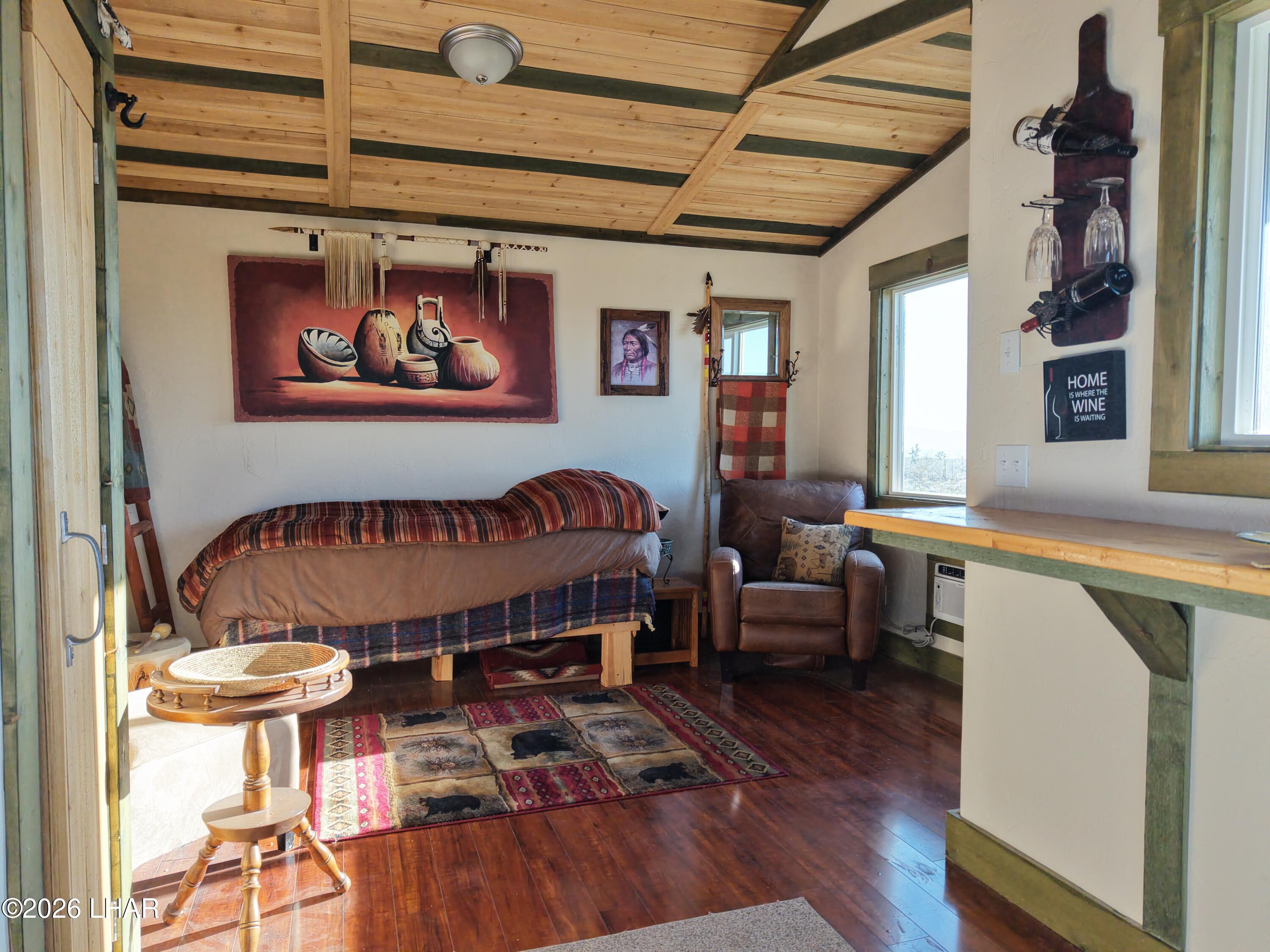 122 South Carrow Road Yucca, AZ 86438 - Photo 30 of 47 a living room with furniture and a wooden floor