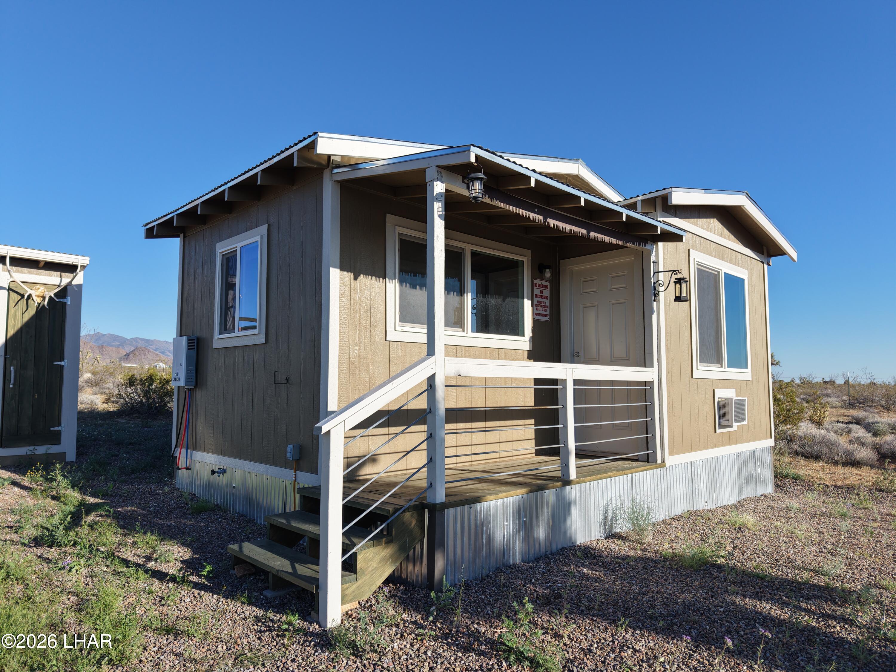 122 South Carrow Road Yucca, AZ 86438 - Photo 4 of 47 a view of a house with a yard