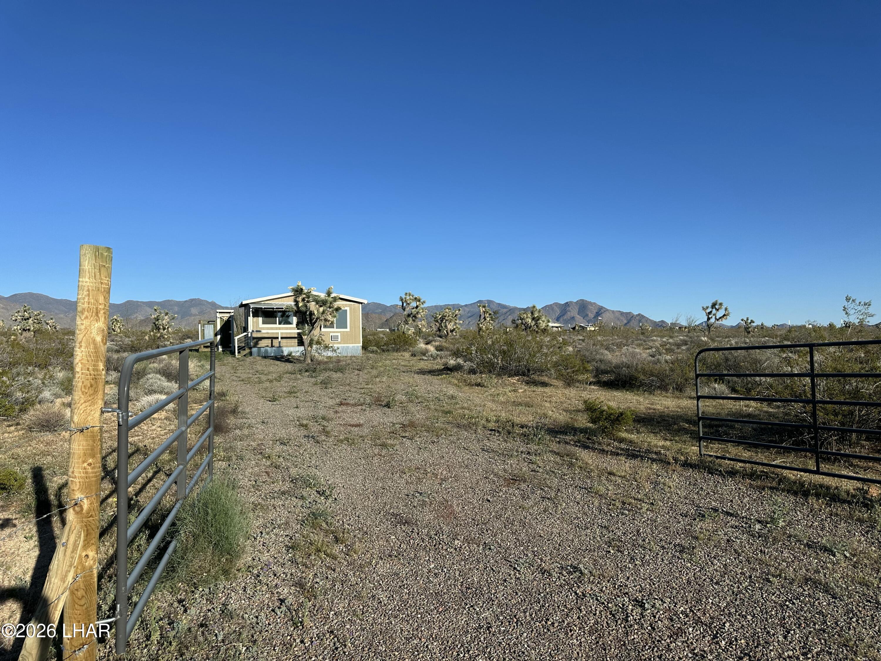 122 South Carrow Road Yucca, AZ 86438 - Photo 46 of 47 a view of a dry yard with wooden fence