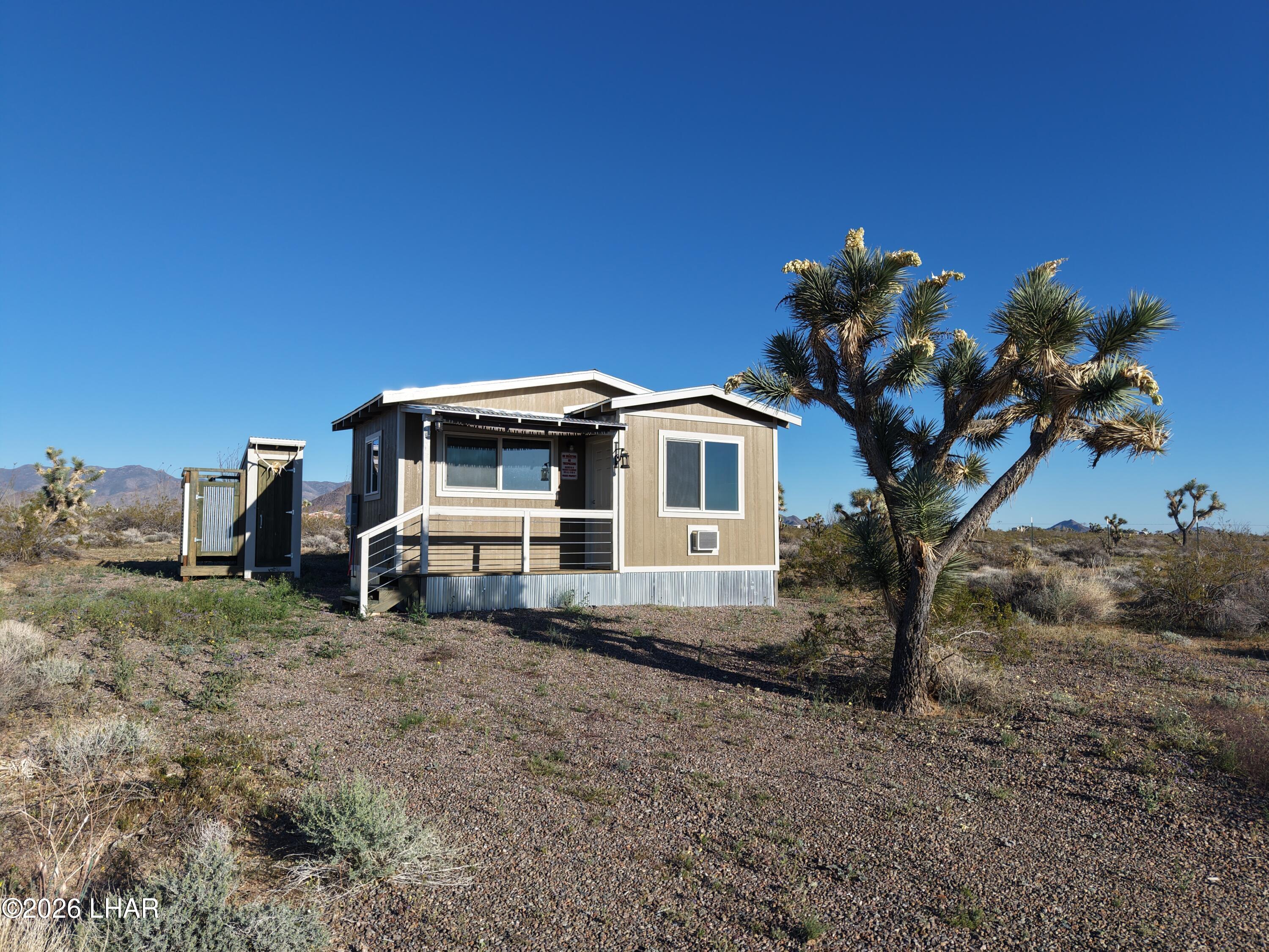 122 South Carrow Road Yucca, AZ 86438 - Photo 5 of 47 a view of a house with a yard
