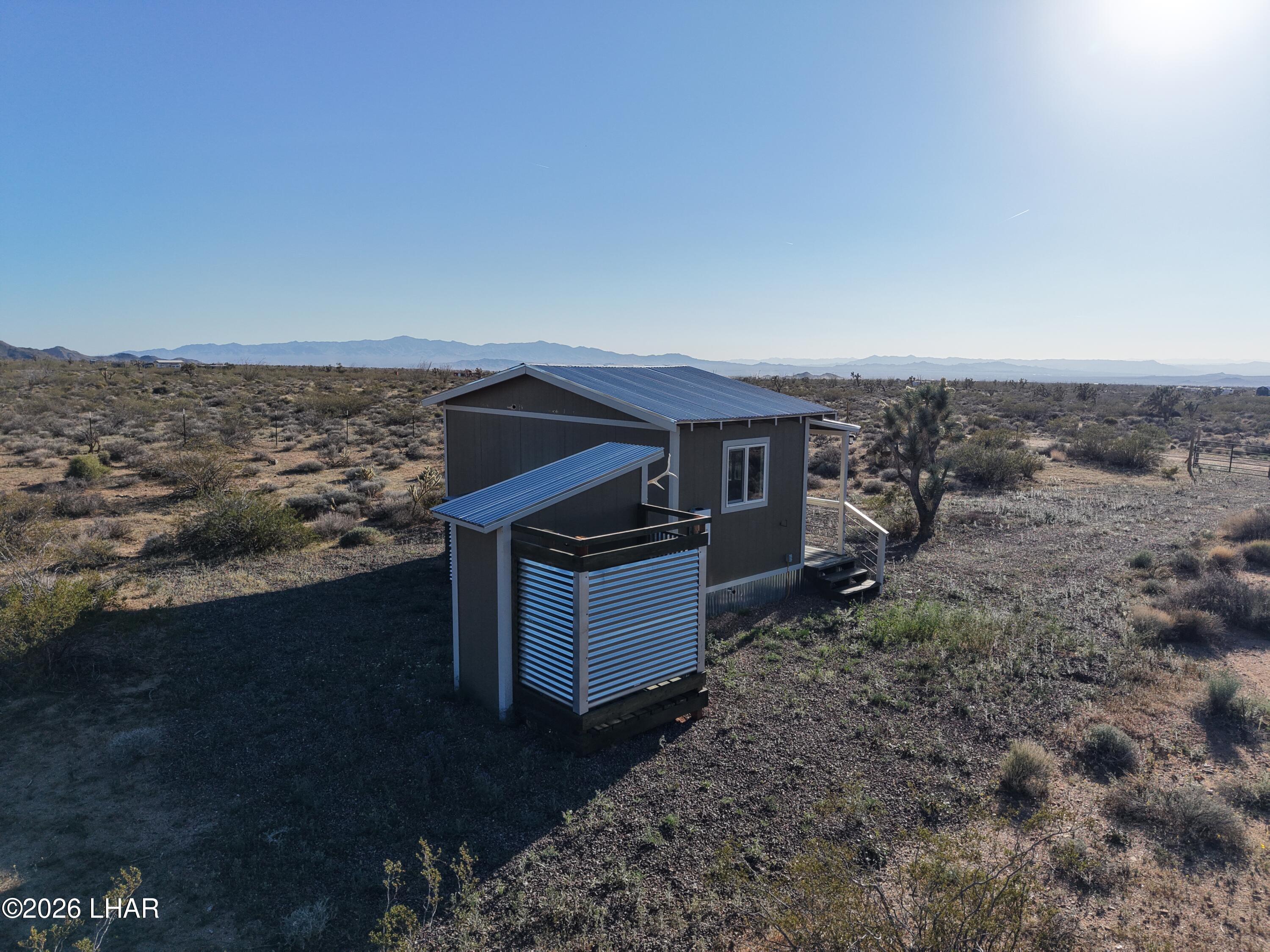 122 South Carrow Road Yucca, AZ 86438 - Photo 9 of 47 a aerial view of a house with a yard