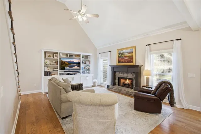 a living room with furniture a fireplace and a flat screen tv