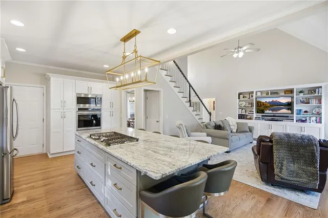 a kitchen with stainless steel appliances granite countertop a stove oven and a refrigerator