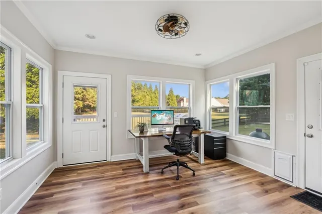 a view of a livingroom with workspace and a window