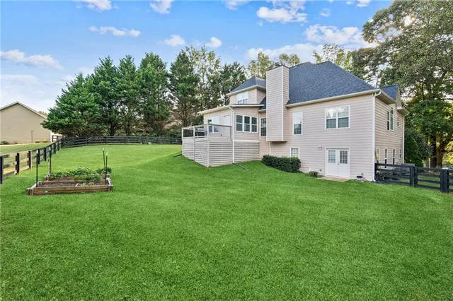 a view of a house with a yard and sitting area
