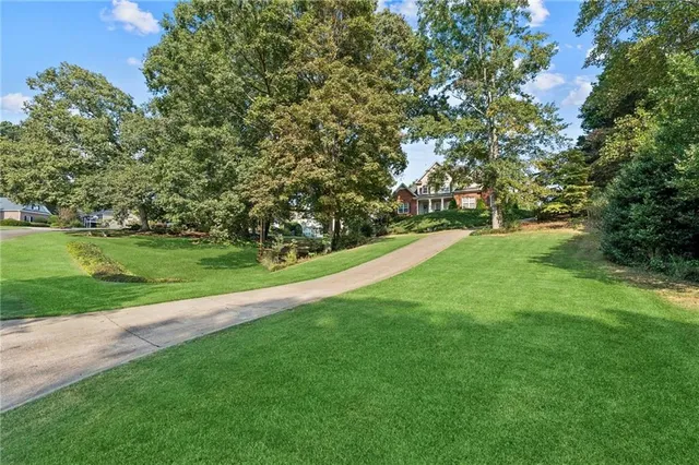 a view of a field of grass and trees