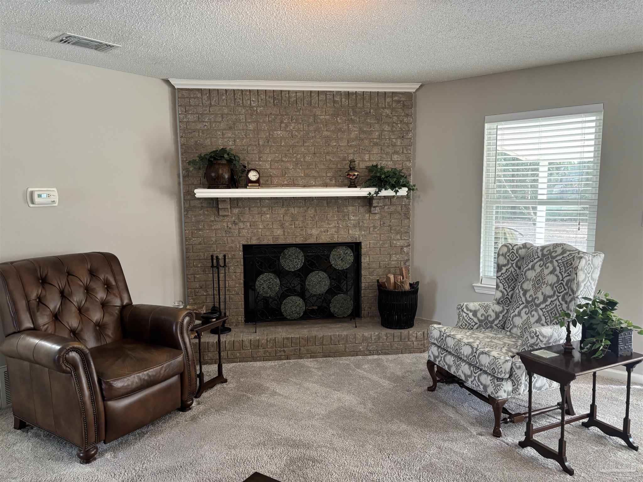 5367 Constitution Road Crestview, FL 32539 - Photo 12 of 29 a living room with furniture and a fireplace
