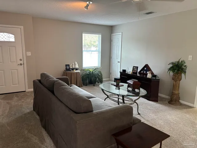a living room with furniture and a potted plant