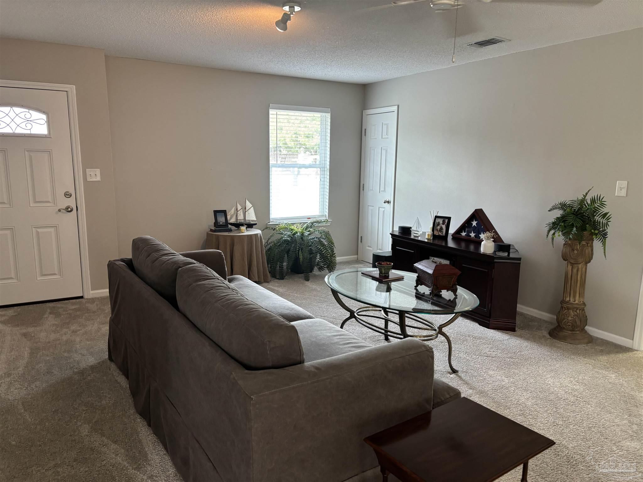 5367 Constitution Road Crestview, FL 32539 - Photo 14 of 29 a living room with furniture and a potted plant