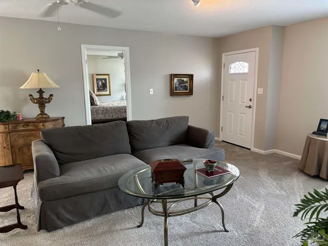 a living room with furniture and a mirror