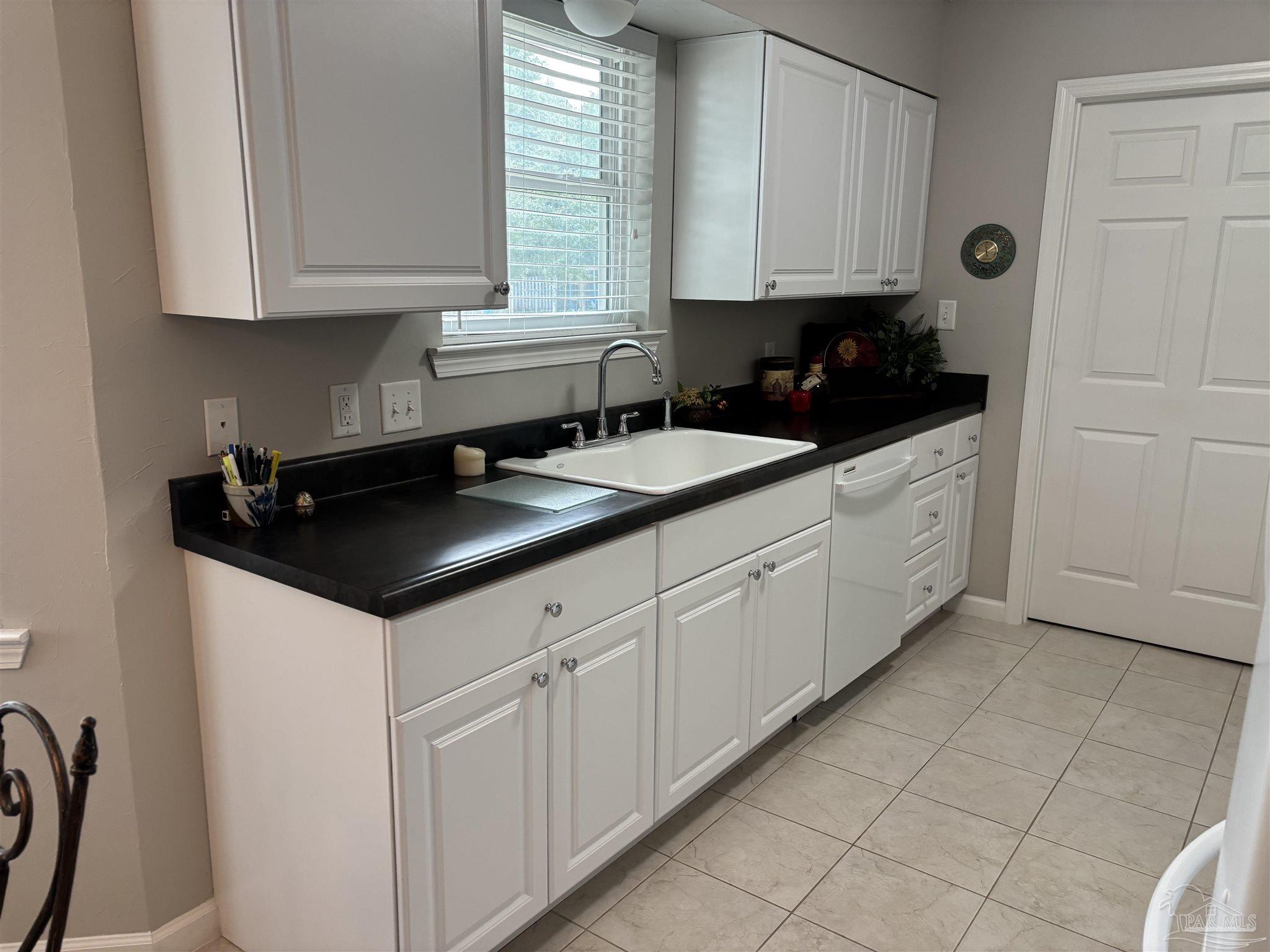 5367 Constitution Road Crestview, FL 32539 - Photo 20 of 29 a kitchen with granite countertop white cabinets and sink