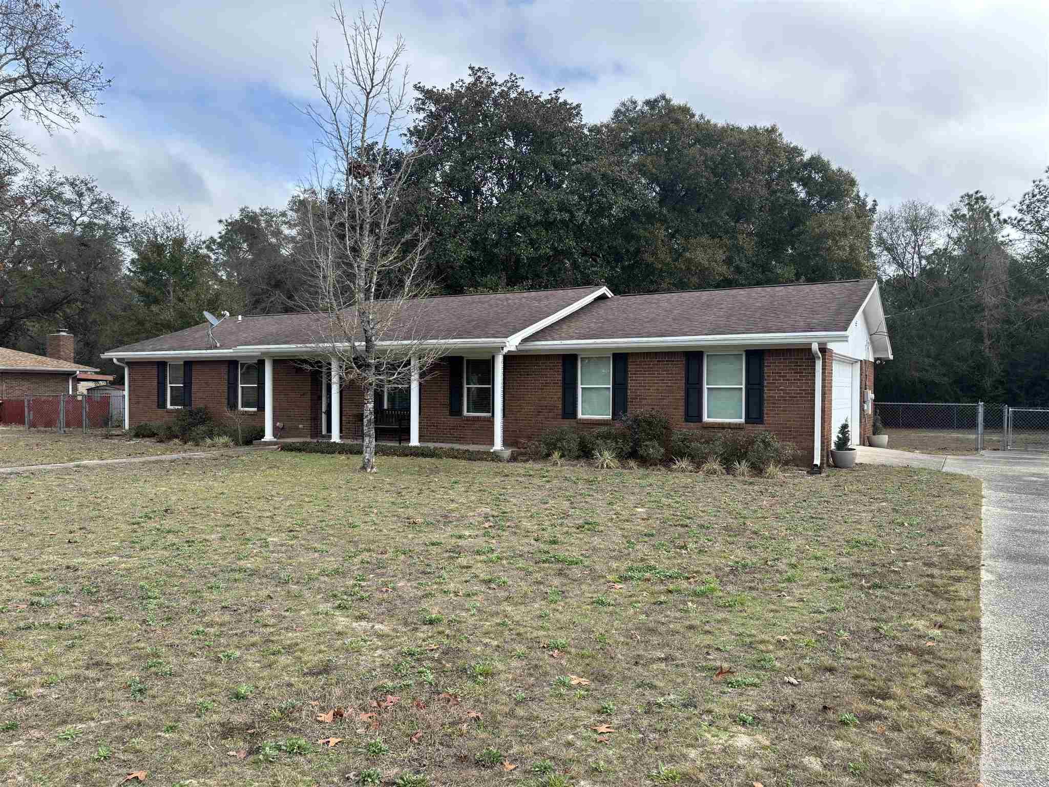 5367 Constitution Road Crestview, FL 32539 - Photo 2 of 29 a front view of a house with a garden