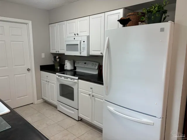 a kitchen with stainless steel appliances a refrigerator sink and cabinets