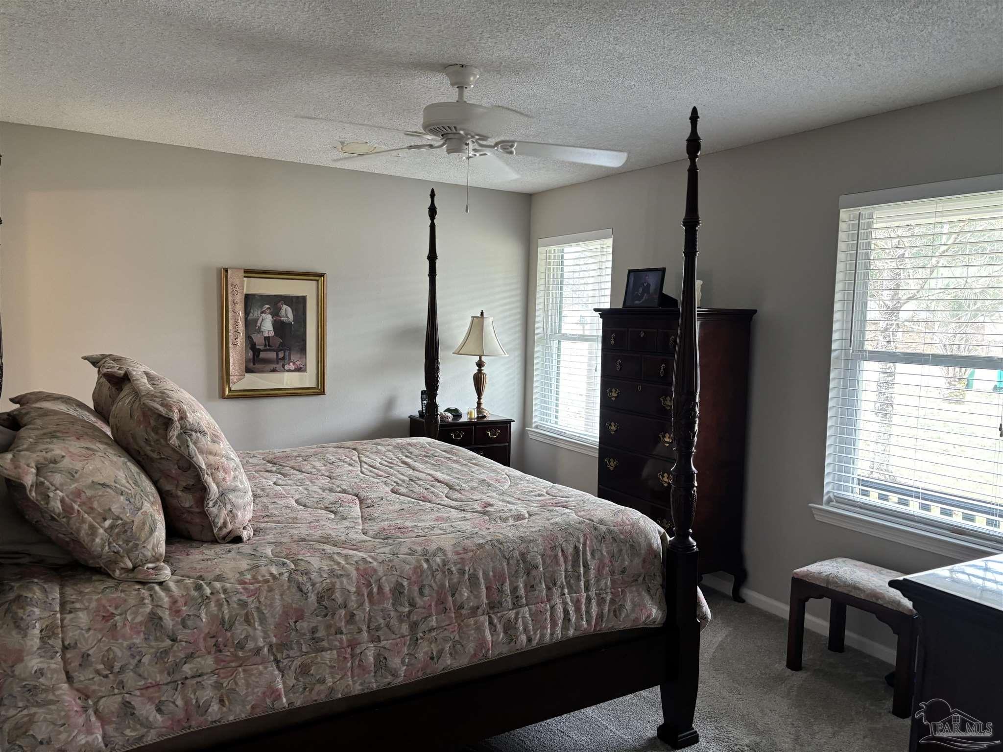 5367 Constitution Road Crestview, FL 32539 - Photo 23 of 29 a bedroom with a large bed and a chandelier