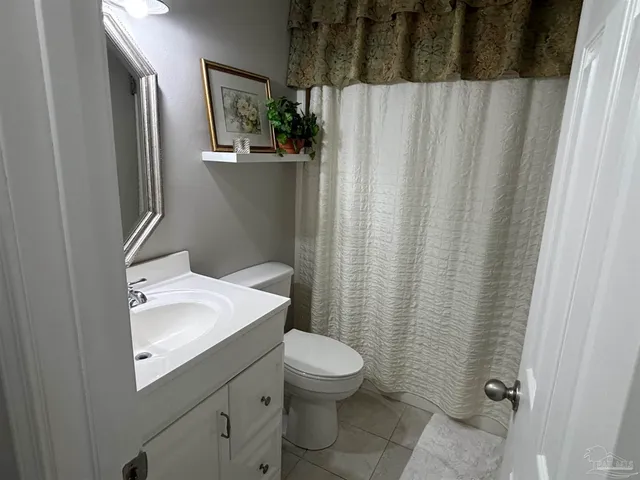 a bathroom with a sink and mirror with toilet