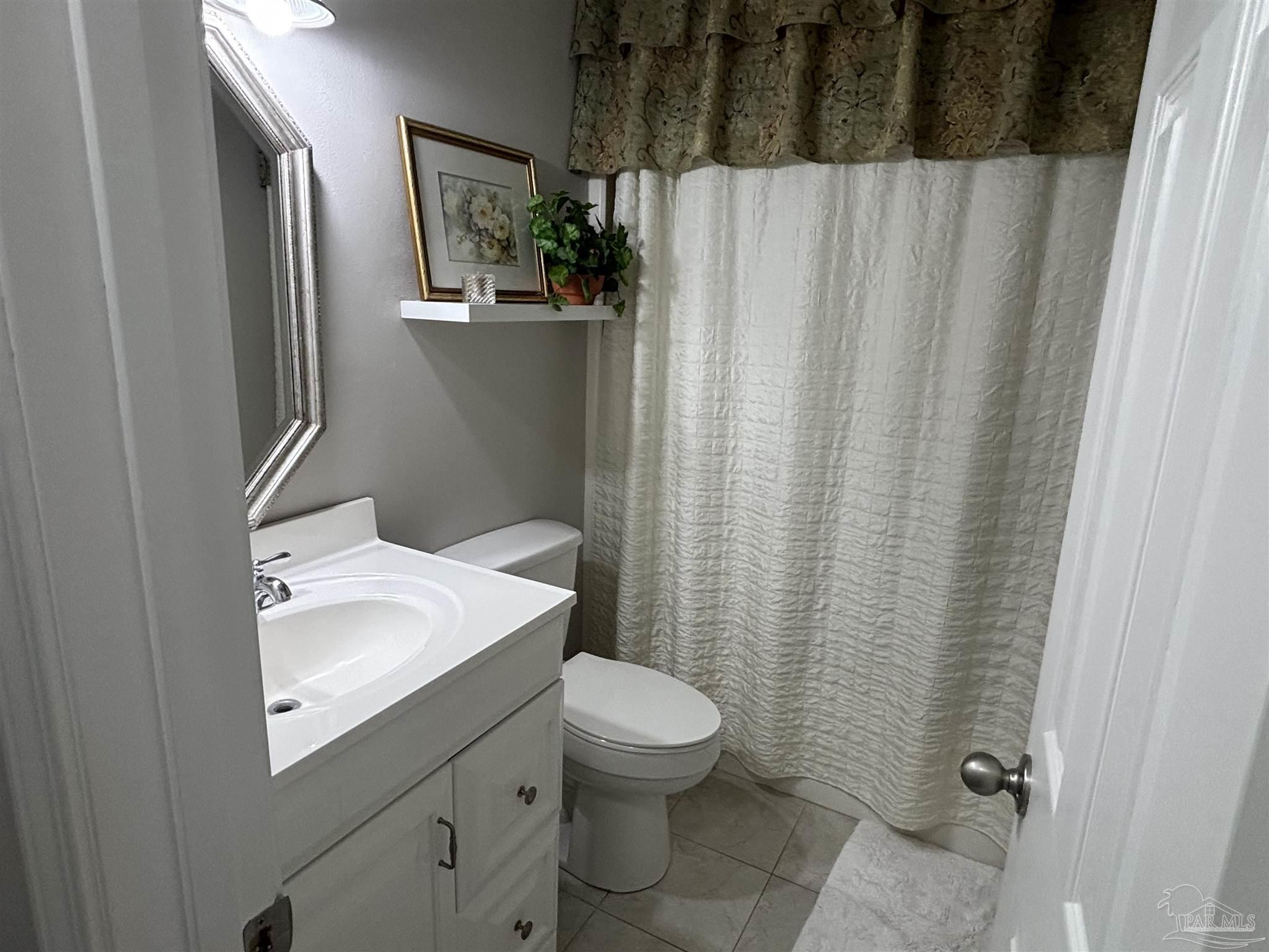 5367 Constitution Road Crestview, FL 32539 - Photo 27 of 29 a bathroom with a sink and mirror with toilet