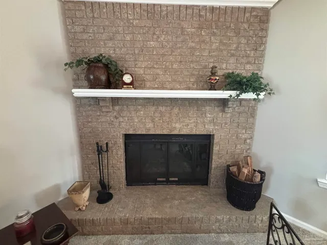 a room with a fireplace and potted plant