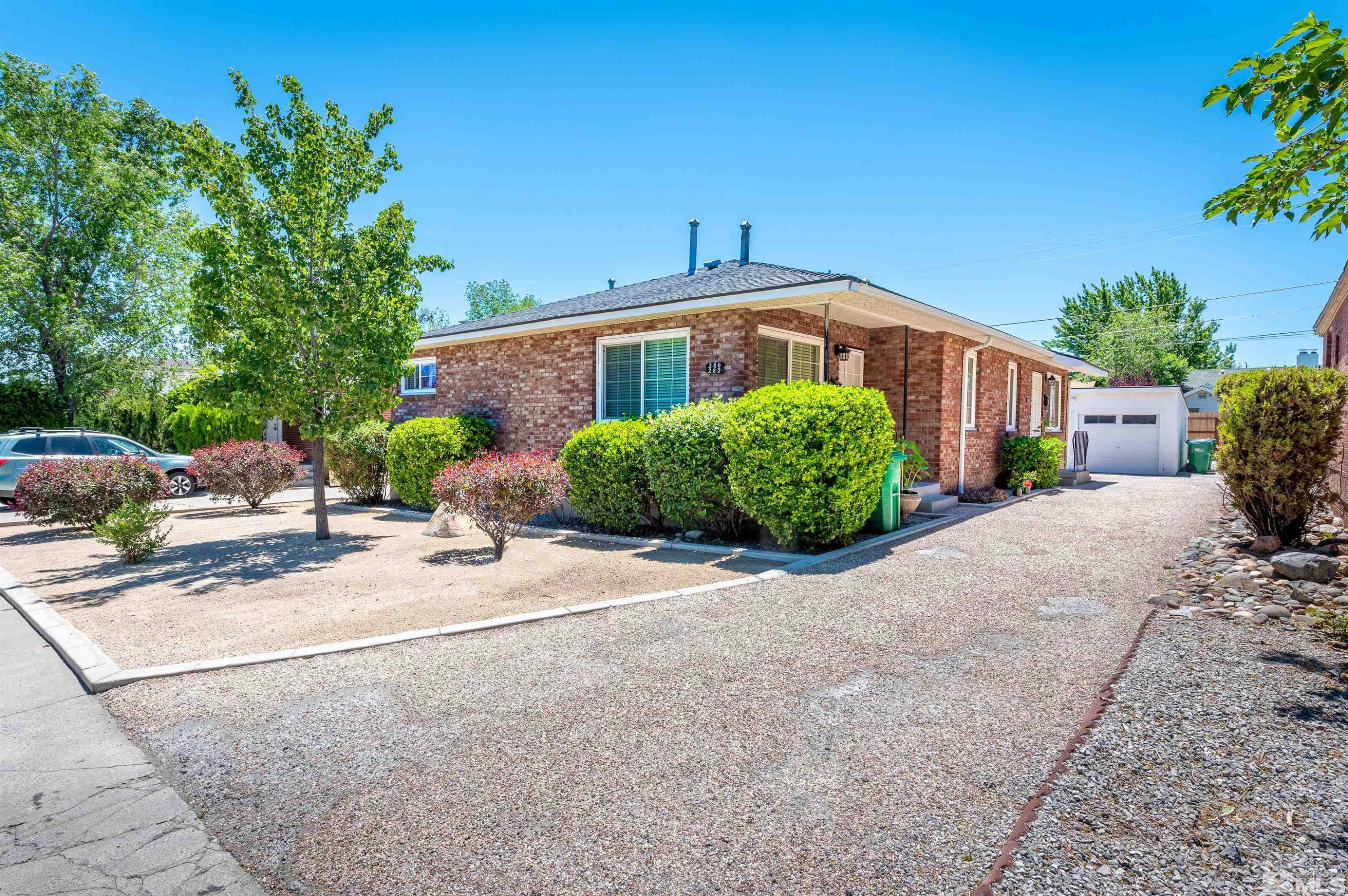 282 Mt Rose Street Reno, NV 89509 - Photo 1 of 22 a front view of a house with a yard and a garage