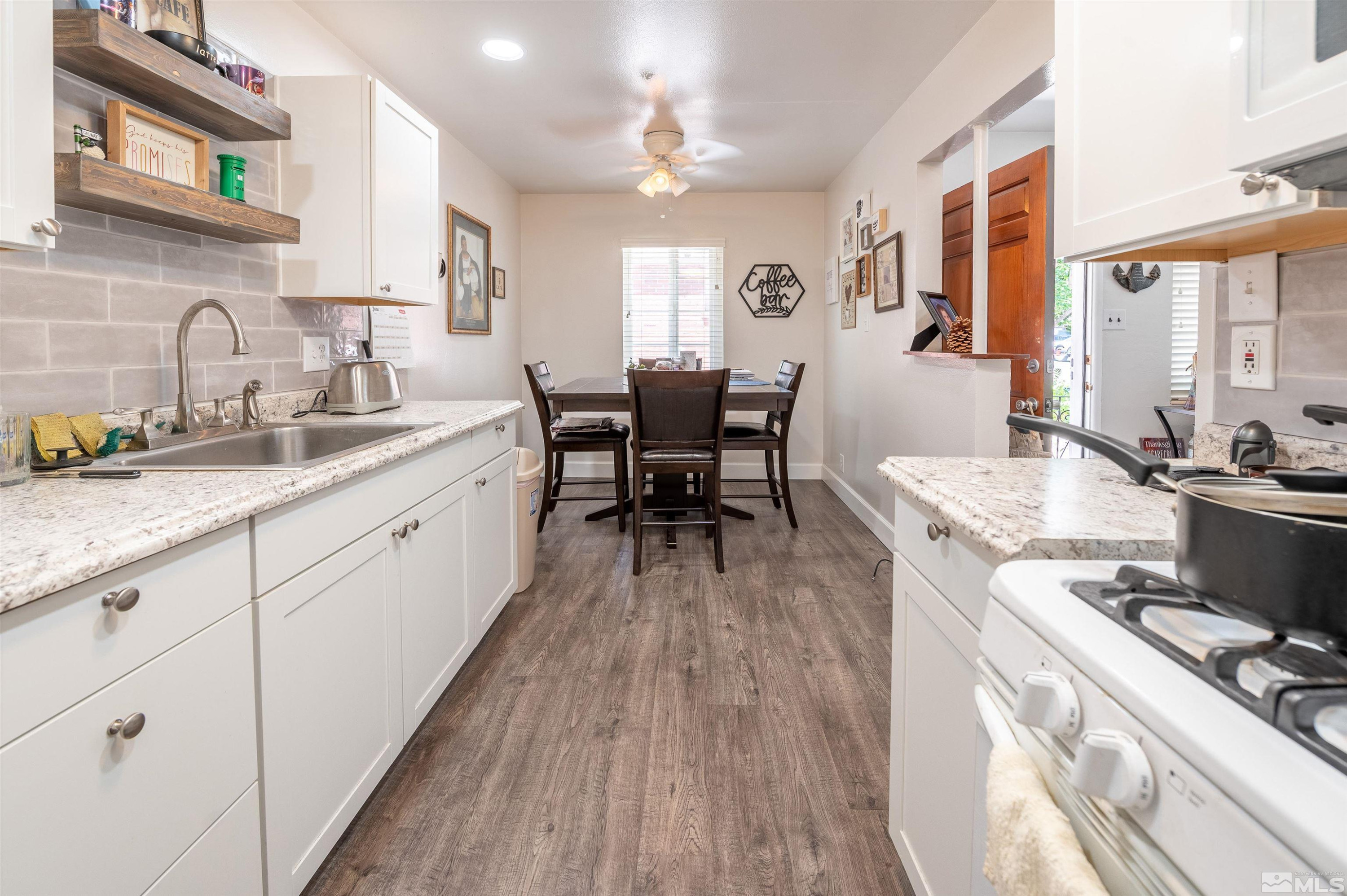 282 Mt Rose Street Reno, NV 89509 - Photo 17 of 22 a large kitchen with cabinets wooden floor and stainless steel appliances