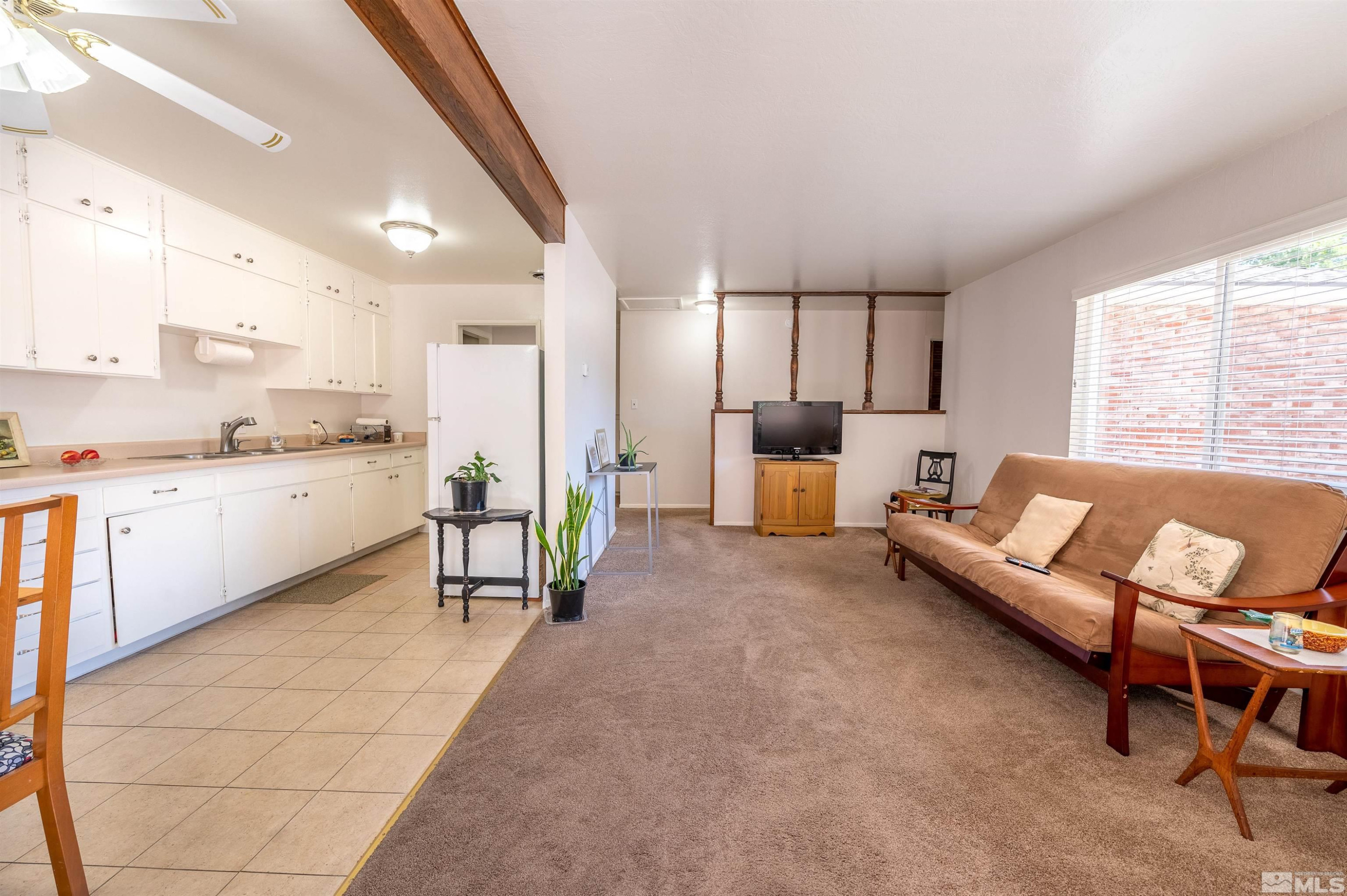 282 Mt Rose Street Reno, NV 89509 - Photo 4 of 22 a living room with furniture and a dining table with kitchen view