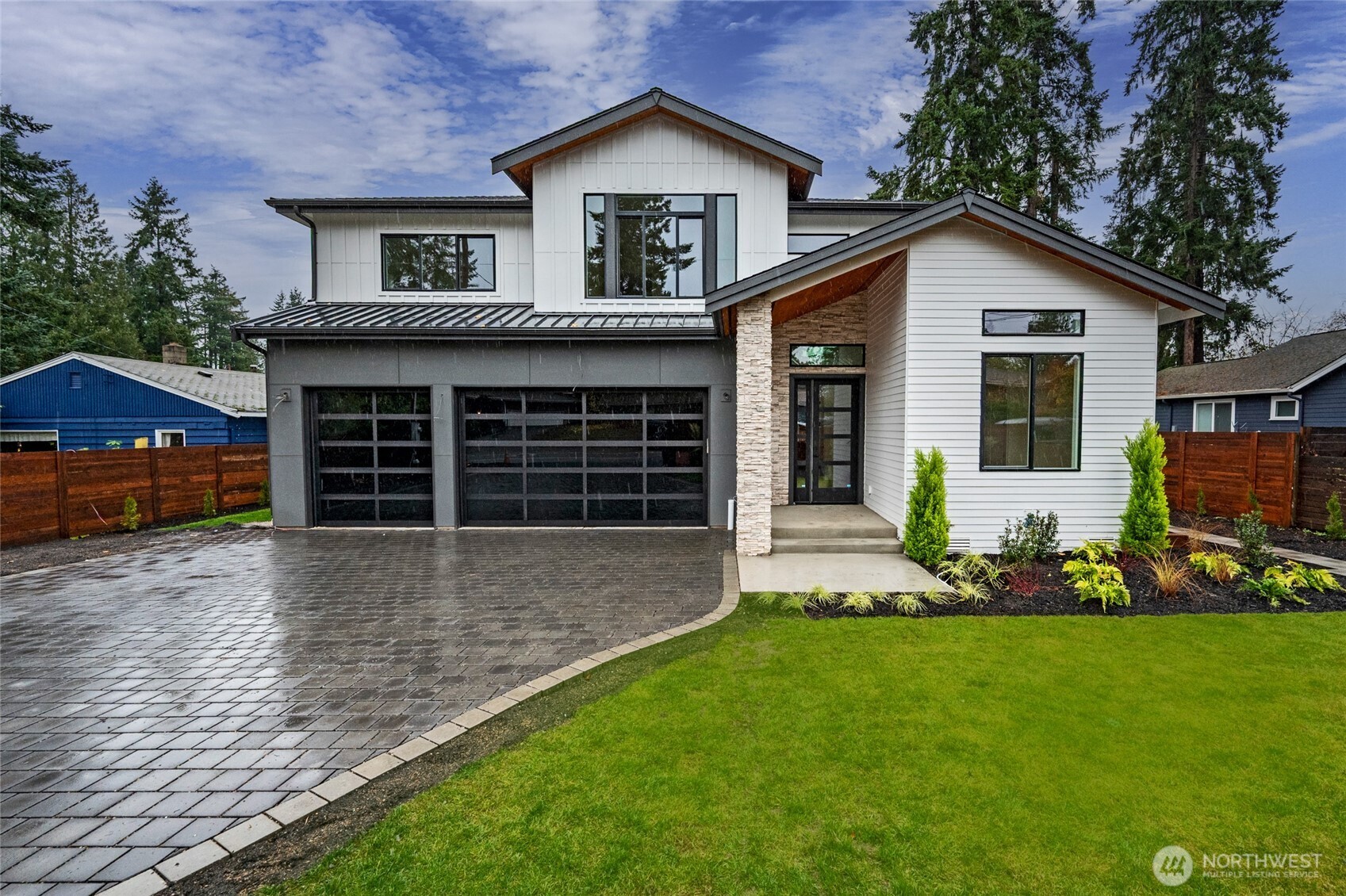 a front view of a house with a garden and yard