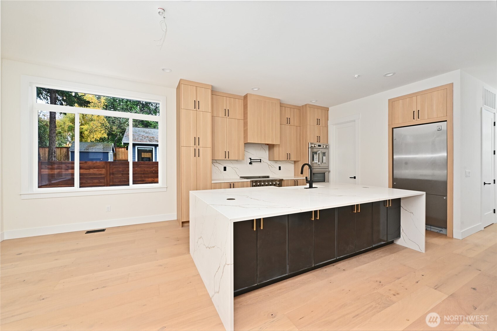 17526 Fremont Avenue North Shoreline, WA 98133 - Photo 8 of 40 a kitchen with stainless steel appliances a sink stove and cabinets
