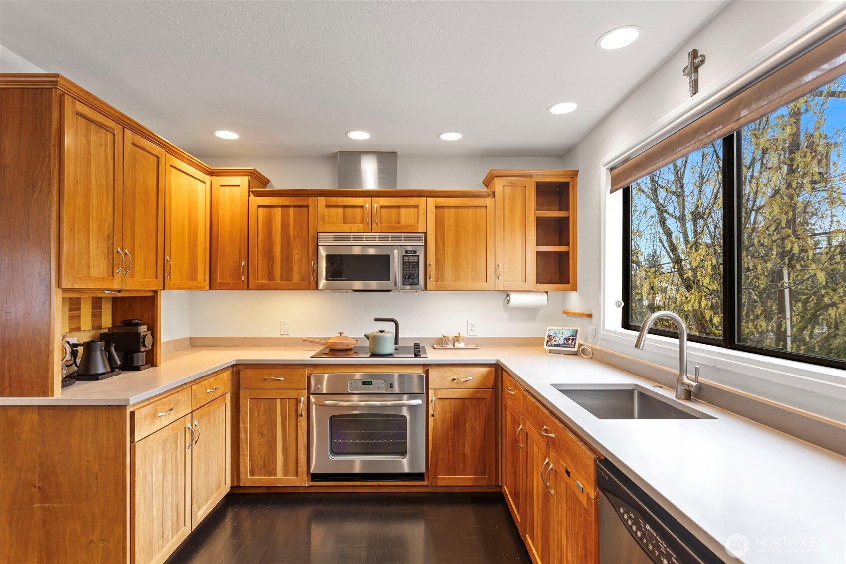 611 State Street, Unit 9 Kirkland, WA 98033 - Photo 11 of 36 a kitchen with stainless steel appliances a sink dishwasher a stove top oven a refrigerator with wooden cabinets and floor