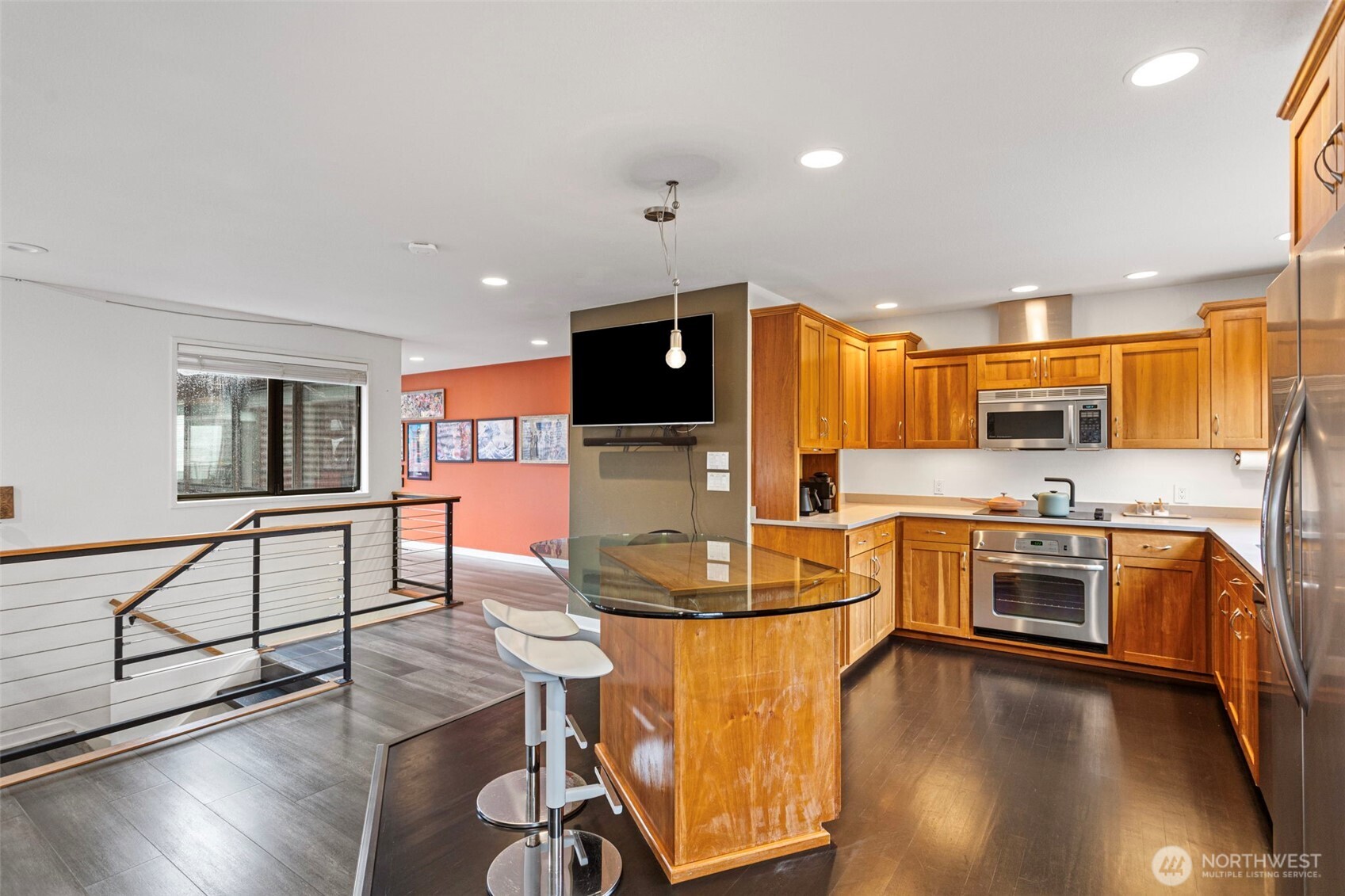 611 State Street, Unit 9 Kirkland, WA 98033 - Photo 14 of 36 a kitchen with stainless steel appliances granite countertop a stove top oven a sink a dining table and chairs with wooden floor