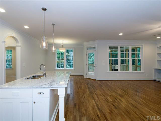 2104 East Charlotte Court Raleigh, NC 27607 - Photo 6 of 23 Granite island with area for barstools. Access to the screened in porch from the family room.