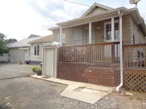 a view of a house with wooden fence