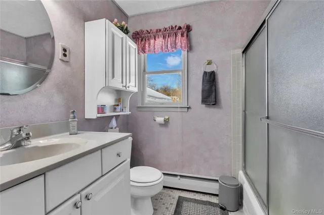 a bathroom with a sink a toilet and a mirror
