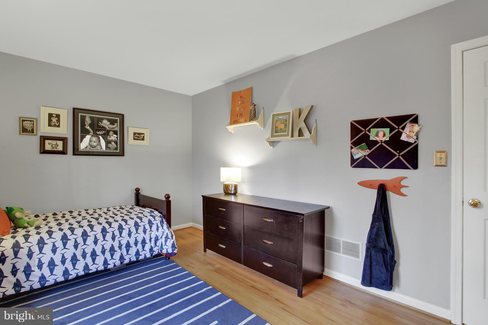 14405 Manor Road Phoenix, MD 21131 - Photo 22 of 30 a bedroom with a bed and a lamp on dresser