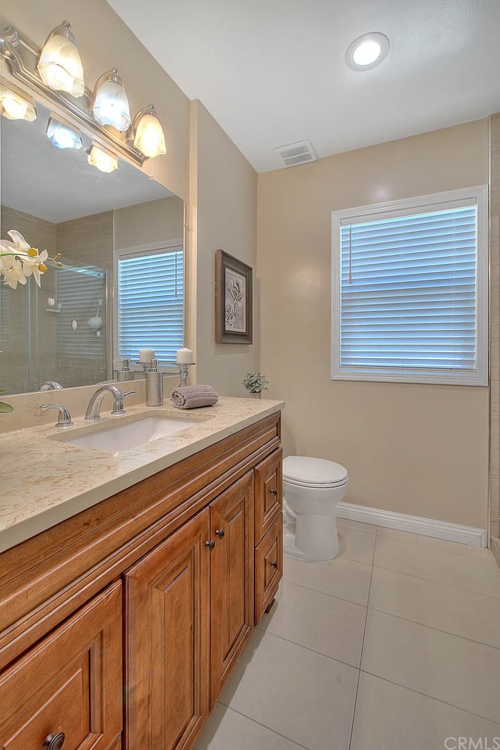 2509 Pine Valley Drive Alhambra, CA 91803 - Photo 33 of 63 a bathroom with a granite countertop sink a toilet and a mirror