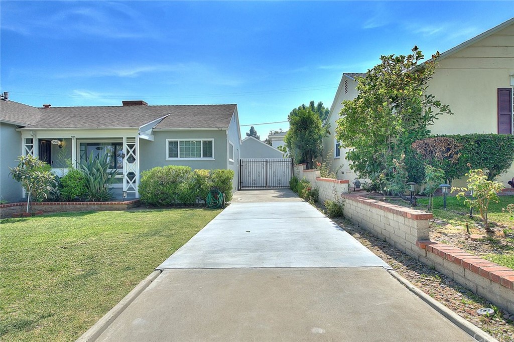 2509 Pine Valley Drive Alhambra, CA 91803 - Photo 58 of 63 a front view of a house with a yard and potted plants