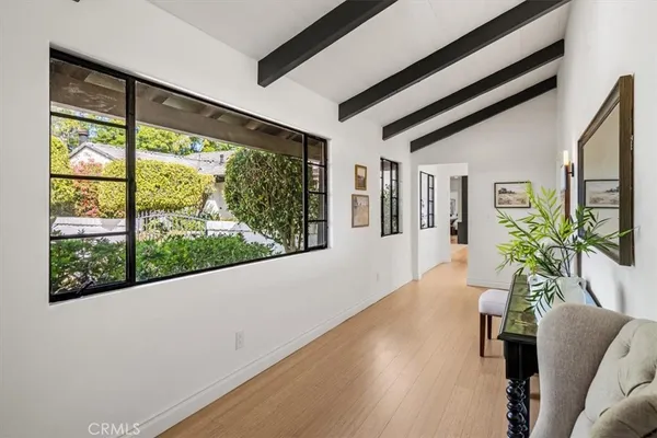 a view of a living room and floor to ceiling windows