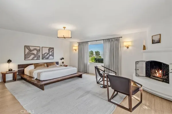 a spacious bedroom with a bed and a fireplace