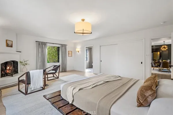 a bedroom with furniture and a fireplace