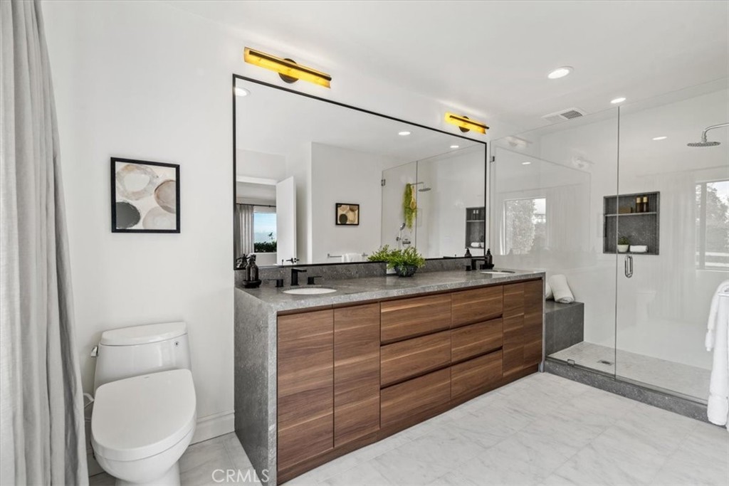 19 Wideloop Road Rolling Hills, CA 90274 - Photo 19 of 35 a bathroom with a toilet a sink and mirror