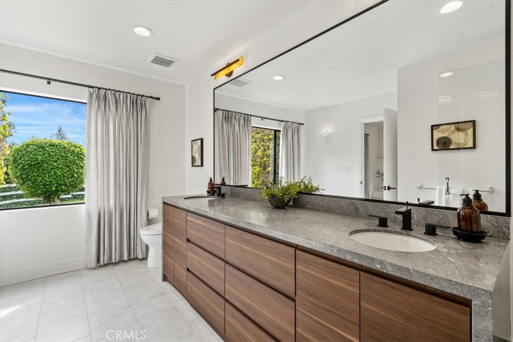 19 Wideloop Road Rolling Hills, CA 90274 - Photo 20 of 35 a bathroom with double vanity sinks a large mirror and a shower