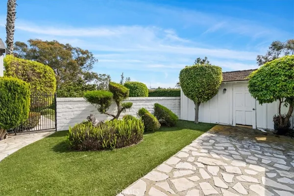 a view of a garden with a building in the background