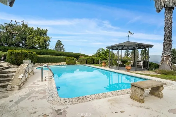 a view of a swimming pool with a lounge chairs